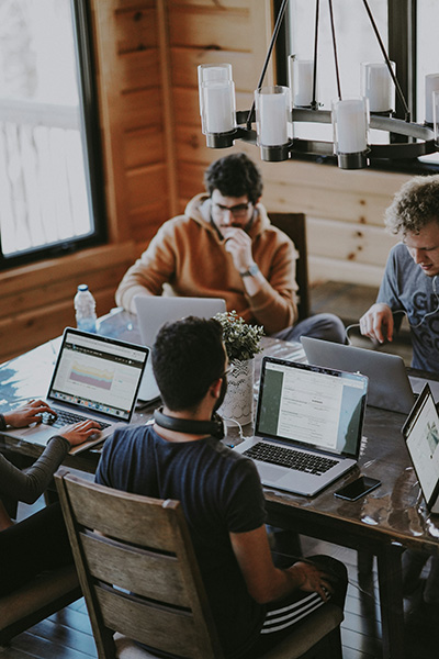 A small group of people with laptops having a meeting.